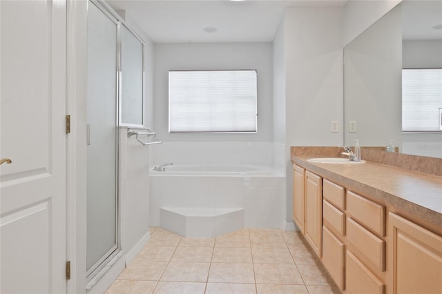 bathroom with plus walk in shower, tile patterned flooring, and vanity