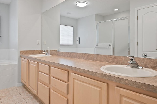 bathroom with tile patterned flooring, vanity, and independent shower and bath