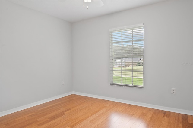 empty room with hardwood / wood-style floors and ceiling fan