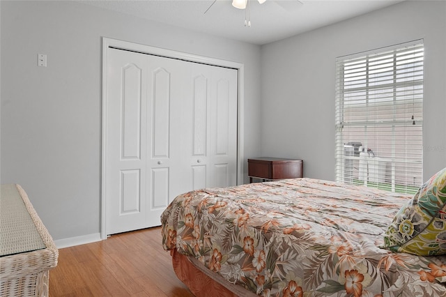 bedroom with light wood-type flooring, a closet, and ceiling fan