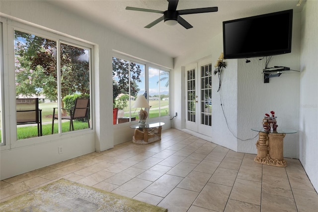 unfurnished sunroom featuring ceiling fan