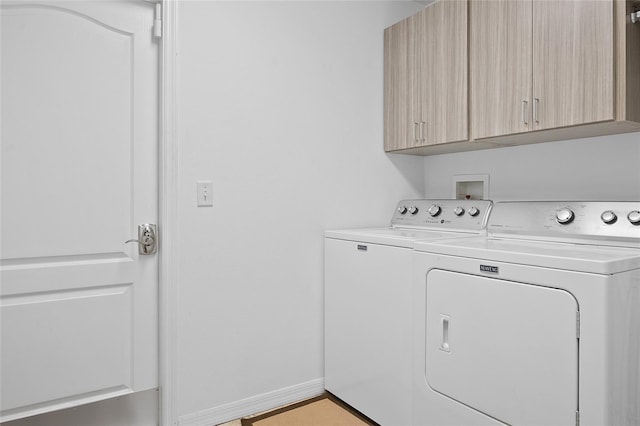 washroom featuring washer and dryer and cabinets