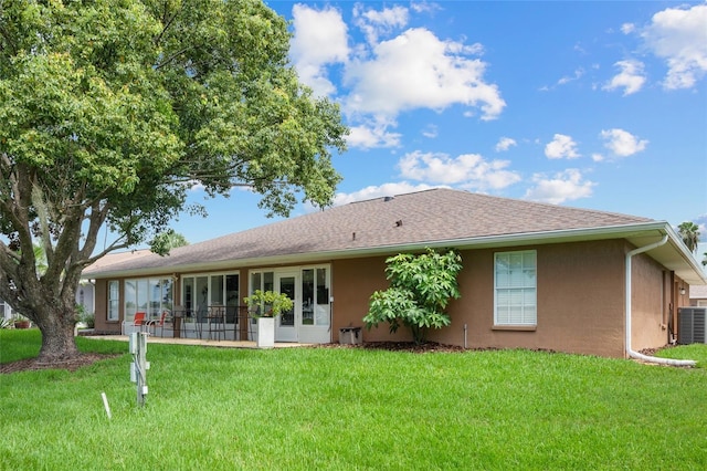 rear view of property with a lawn