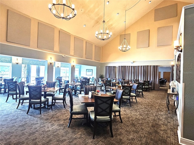 dining area featuring dark carpet, an inviting chandelier, and high vaulted ceiling