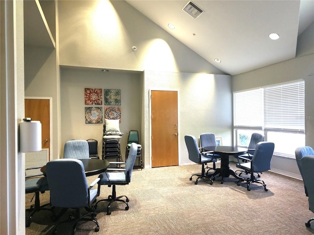 office space with carpet floors and high vaulted ceiling