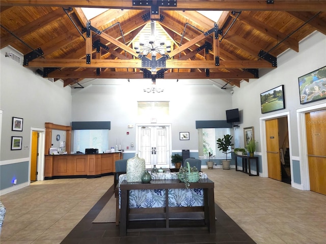 living room with beam ceiling, high vaulted ceiling, a chandelier, and wood ceiling