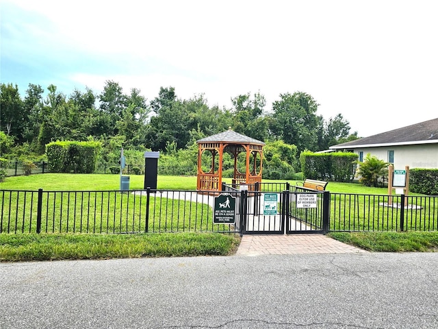 view of gate featuring a gazebo and a yard