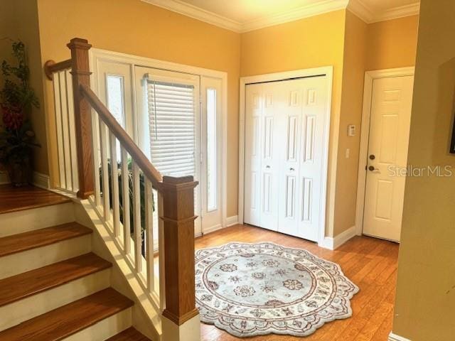 entryway featuring light hardwood / wood-style floors and ornamental molding