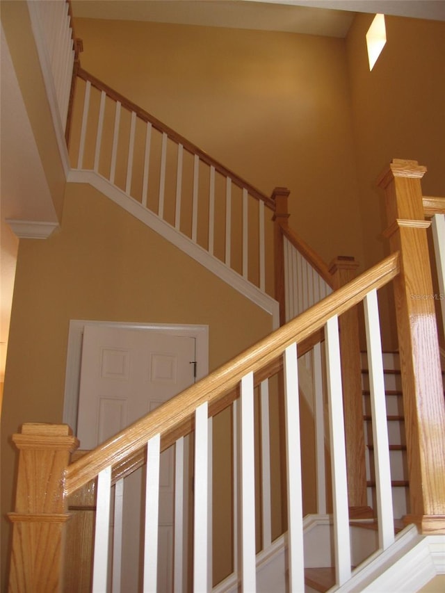 staircase with a high ceiling