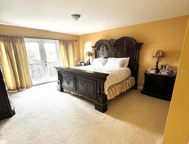 carpeted bedroom featuring access to outside, french doors, and a textured ceiling