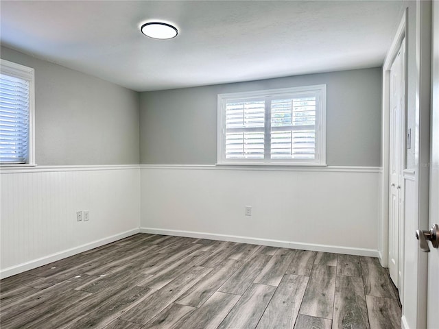 unfurnished room with wood-type flooring