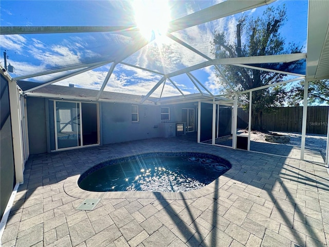 view of swimming pool with a lanai and a patio area