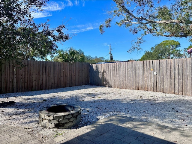 view of yard with a fire pit