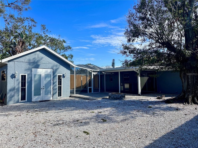 back of house featuring an outdoor fire pit