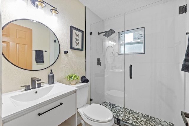 bathroom featuring vanity, toilet, and a shower with shower door