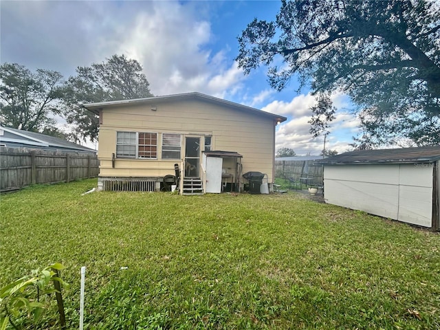 rear view of property with a lawn