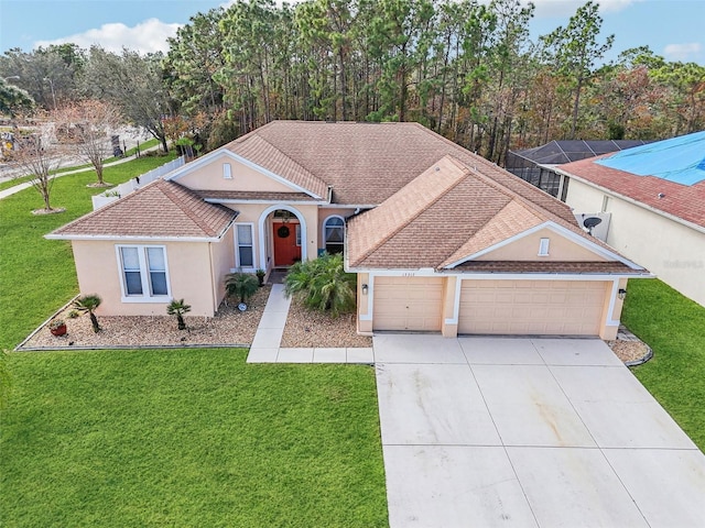 single story home featuring a garage and a front lawn