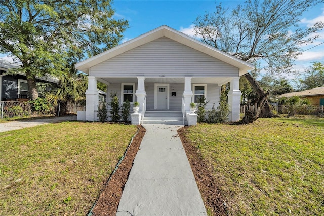 bungalow-style house with a porch and a front yard