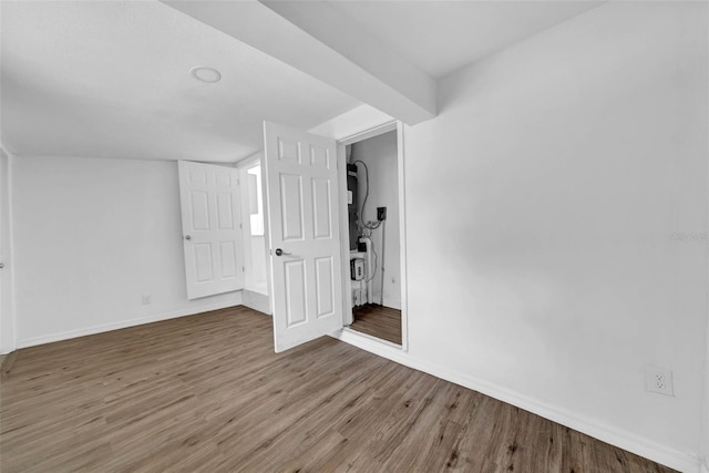 empty room with hardwood / wood-style flooring