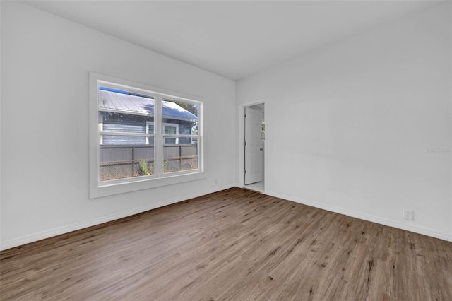 empty room with light hardwood / wood-style floors