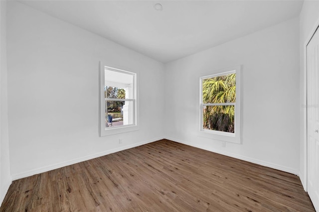 empty room featuring hardwood / wood-style flooring and plenty of natural light