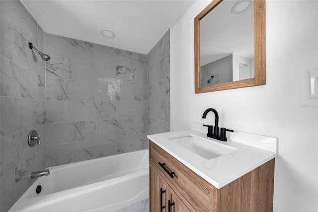 bathroom with vanity and tiled shower / bath