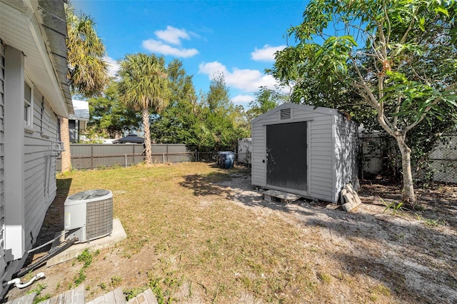 view of yard with central AC and a storage unit