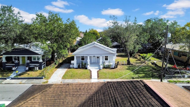 bungalow-style home with a front yard