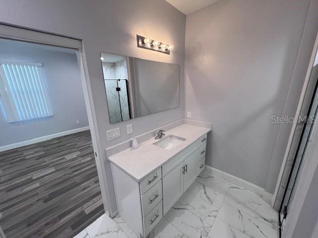 bathroom featuring walk in shower and vanity