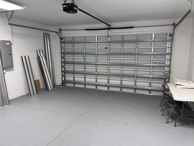 garage with a garage door opener and electric panel