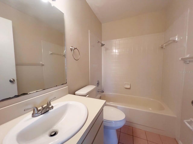 full bathroom featuring toilet, tiled shower / bath combo, tile patterned flooring, and vanity