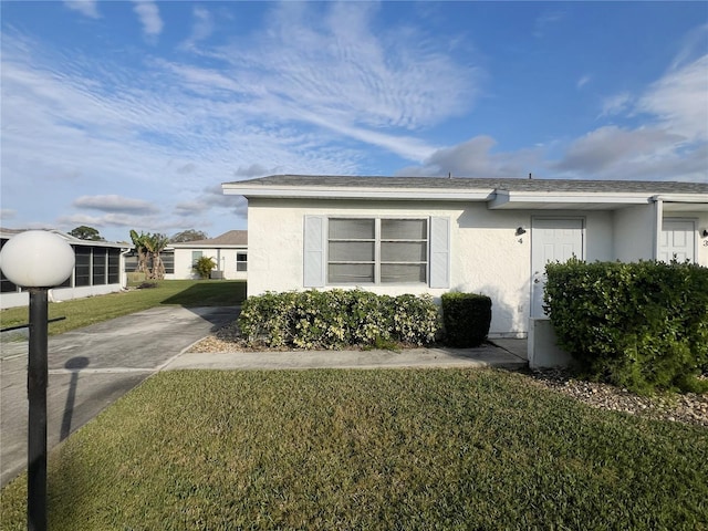 view of side of property with a lawn