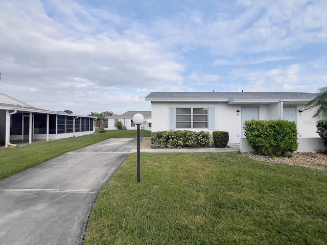 view of front of property featuring a sunroom and a front yard