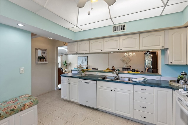 kitchen featuring white dishwasher, ceiling fan, white cabinetry, and sink