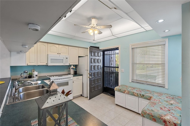 kitchen featuring ceiling fan, sink, light tile patterned floors, and white appliances