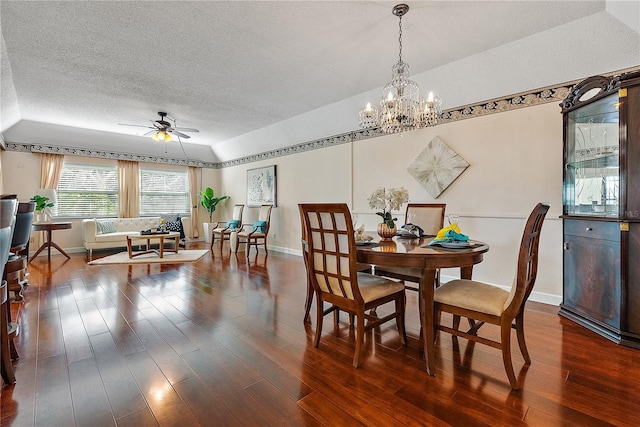 dining space featuring a textured ceiling, dark wood-type flooring, and ceiling fan with notable chandelier