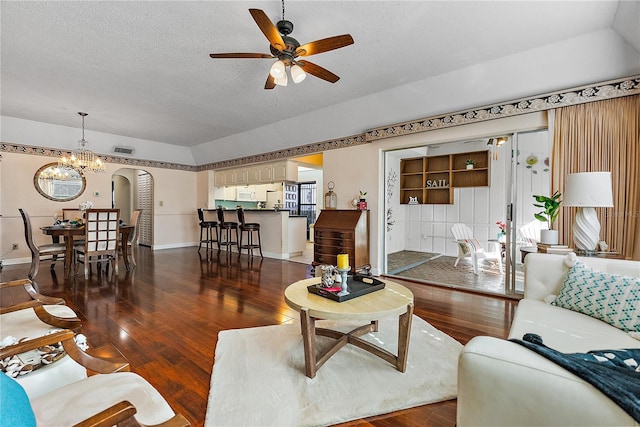 living room featuring a textured ceiling, ceiling fan with notable chandelier, and dark hardwood / wood-style floors