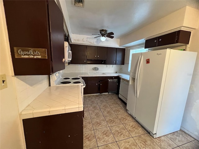 kitchen featuring backsplash, light tile patterned floors, dark brown cabinetry, ceiling fan, and white appliances