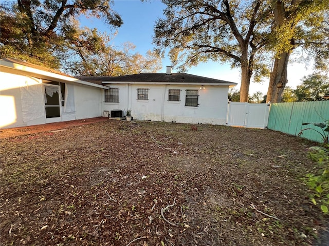 back of property featuring central AC