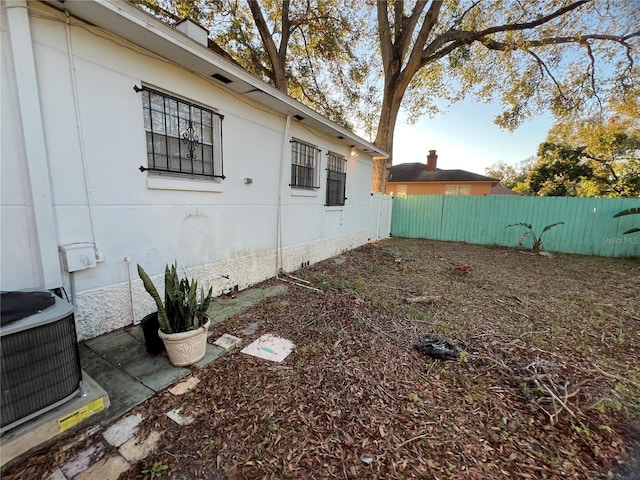 view of side of property with central AC unit