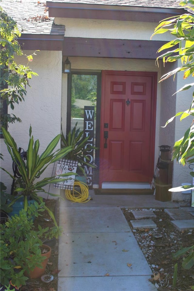 property entrance with stucco siding