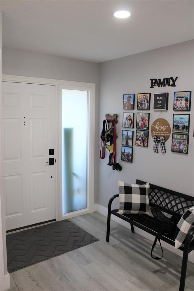 foyer with baseboards and light wood finished floors