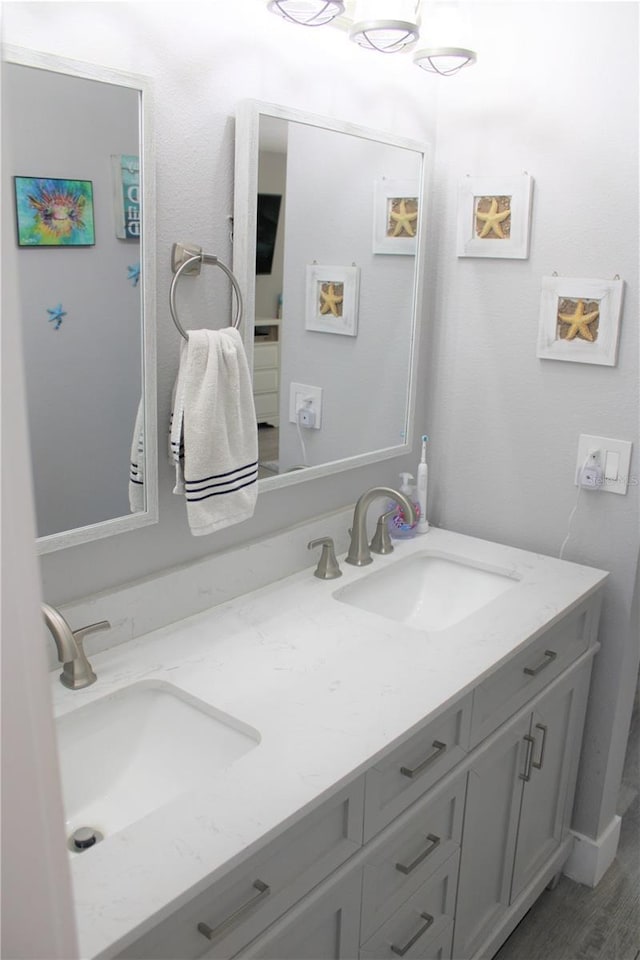 full bath featuring double vanity and a sink