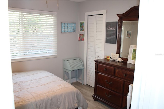 bedroom featuring light wood-type flooring and multiple windows