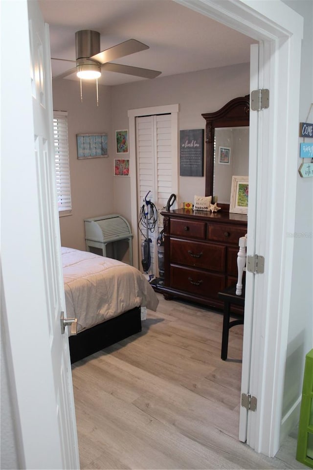 bedroom with a ceiling fan and light wood-style floors