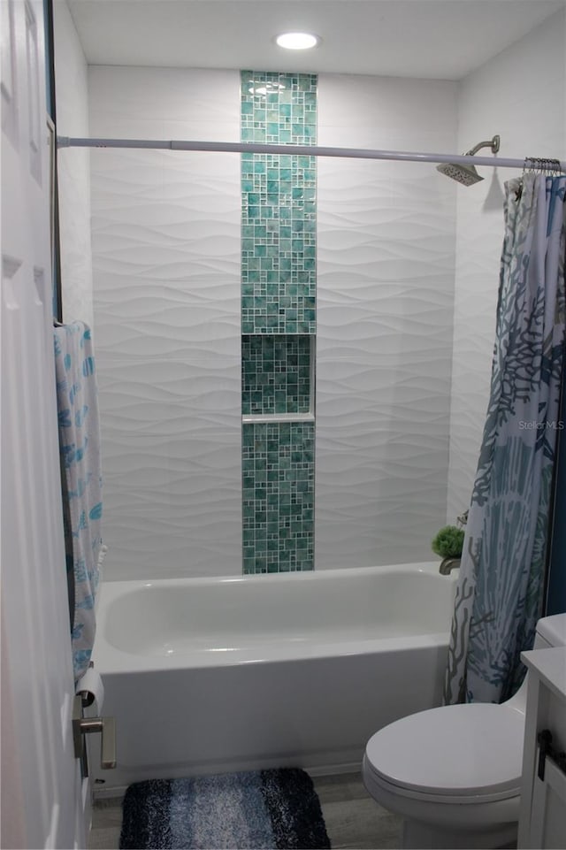 bathroom featuring shower / tub combo with curtain, vanity, toilet, and wood finished floors