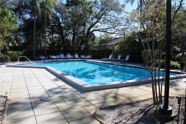 view of swimming pool featuring a fenced in pool, a patio area, and fence