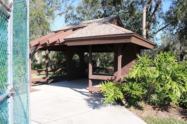 view of property's community featuring concrete driveway and a gazebo