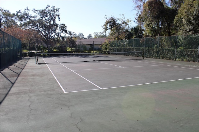 view of tennis court with fence