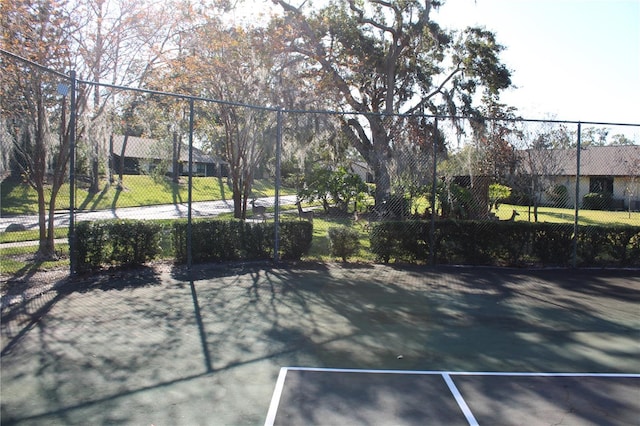 view of tennis court with fence